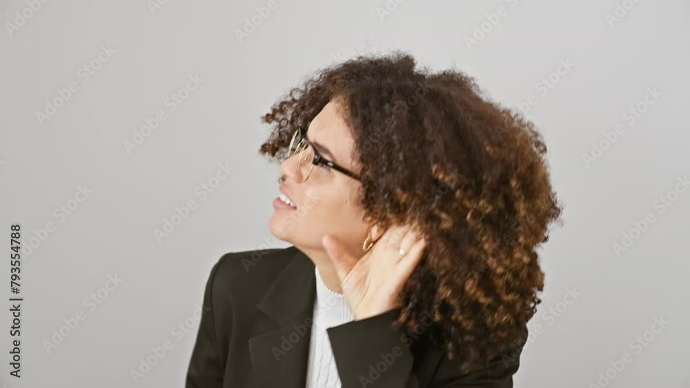 Hispanic woman with curly hair, hand to ear, smiling while listening to gossip, old wives' tale or rumor - deafness concept. isolated on white background