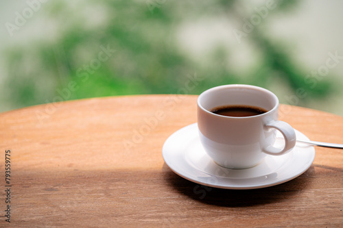 cup of coffee on wooden table © Hide_Studio