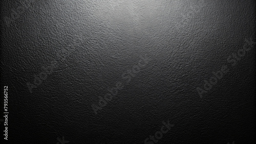 Grunge dark gray textured background with a hint of light reflecting off the rough surface