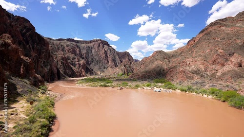view from the middle of Black South Kaibab suspension bridge over the muddy Colorado River where river rafting occurs in the Grand Canyon photo