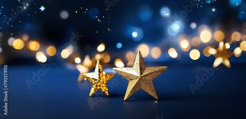 Christmas Background With Golden Stars And Bokeh Lights On Dark Blue © MDSAYDUL