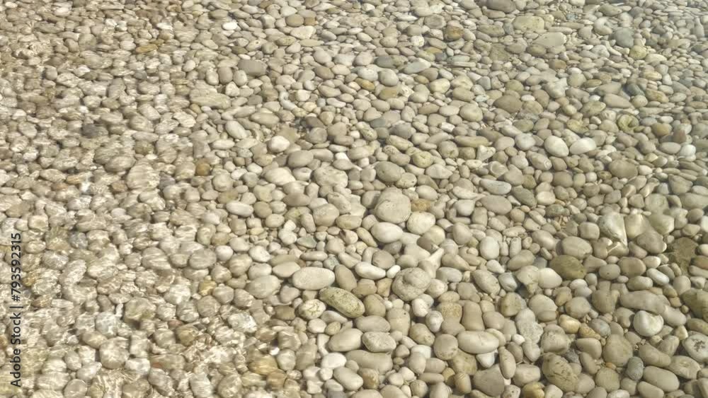 CLOSE UP: Mesmerizing view of tranquil movement of water over a pebble beach. A peaceful and meditative summer scene from the Adriatic beach, when the crystal clear sea flows over the white stones. CLOSE UP: Mesmerizing view of tranquil movement of water over a pebble beach. A peaceful and meditative summer scene from the Adriatic beach, when the crystal clear sea flows over the white stones.
