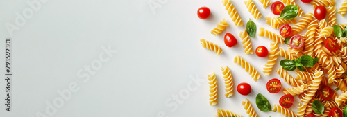 Italian fusilli pasta accompanied by cherry tomatoes and fresh basil. Copy space. Banner. The concept of healthy eating, nutritionology.