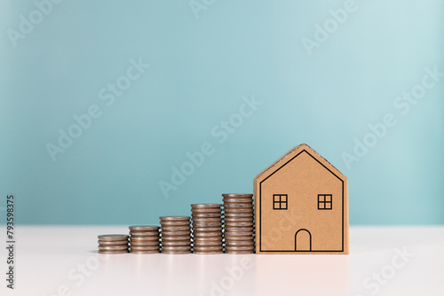 Money saving, real estate investment,mortgage, finance for property, and investing for home lone. Mini model house with coins stack for saving money to buy a house