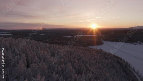 Scenery of a forest at Oy Levi Ski Resort at sunset time in Kittila, Finland during winter season photo