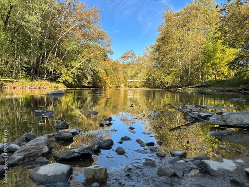 Creek with calm mirror-like water on a fall day in East Liverpool Ohio
