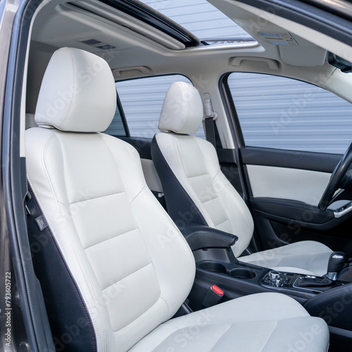 Leather interior design, car passenger and driver seats, clean, wide angle view, white perforated leather