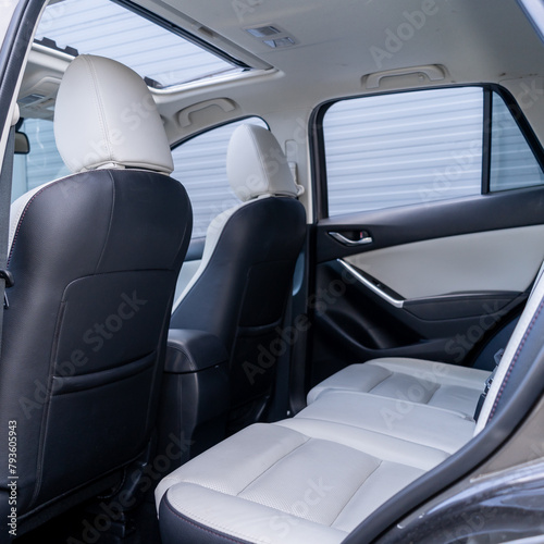 Leather interior design, car passenger and driver seats, clean, wide angle view, white perforated leather photo