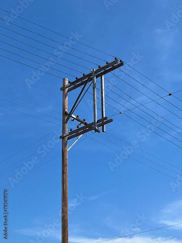 Electricity pylon under blue sky