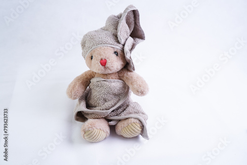 A stuffed bunny toy in a bath towel on its head
