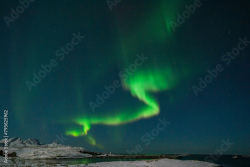 Wide angle shot of the aurora borealis, the northern lights, over the Norwegian islands near Mjelle on a winter evening.