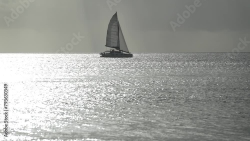 sail boat sailing the Caribbean Sea in barbados island at sunset  photo