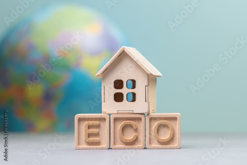 Eco-Friendly Housing Concept with Wooden Blocks and House Model