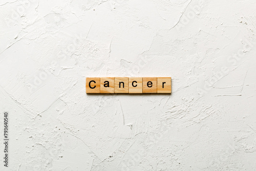 CANCER word written on wood block. CANCER text on cement table for your desing, concept