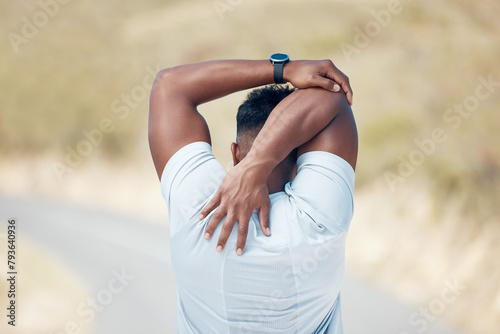 Man, back and stretching with fitness in road for preparation, workout or outdoor exercise. Rear view of male person or athlete in body warm up or getting ready for training or mountain run on street
