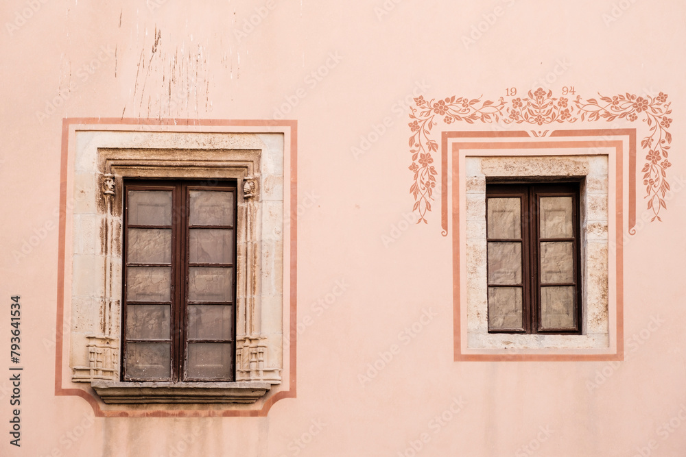 Two asymmetric windows on a facade of a building in Moia, Catalonia (SPAIN)