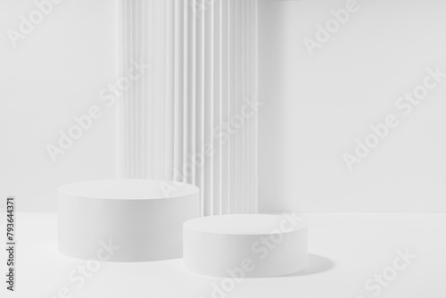 Abstract scene with two white round podiums with striped pillar as decoration, mockup on white background. Template for presentation cosmetic products, gifts, advertising, design in fashion style.