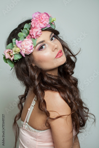 Beautiful healthy woman with clean fresh skin, wavy long hair and flower wreath, beauty portrait