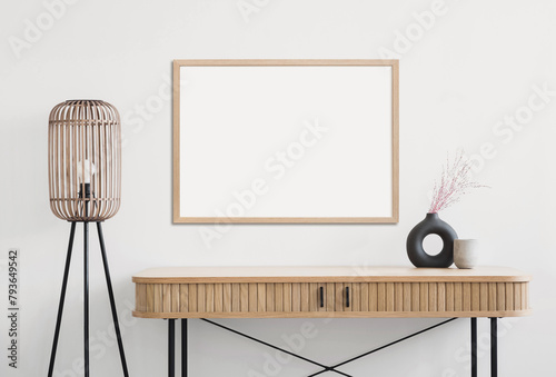 Empty horizontal frame mockup in modern minimalist interior with plant in trendy vase on white wall background. Template for artwork, painting, photo or poster © kite_rin