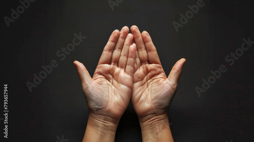 hands praying on black background