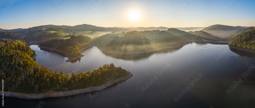 Dreamy view of Vír dam during sunrise in the autumn