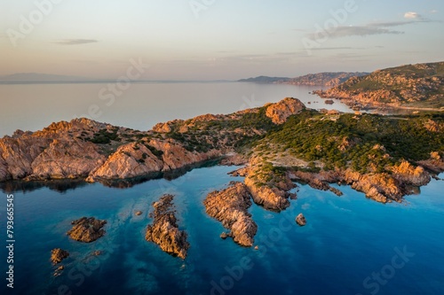 Red cliffs on turquoise water of Sardinia aerial drone view, in Italy