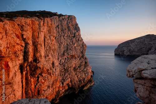 Sea cliffs of Capo Caccia and Foradada island at sunset in Sardinia photo