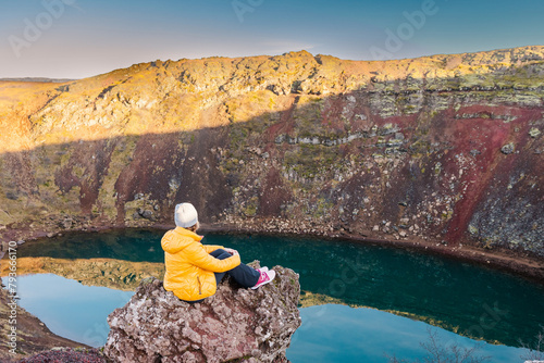 Contemplative solitude overlooking volcanic Kerid crater lake photo