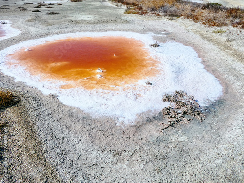 Subsidence funnels on salt marsh are filled with lakes of diverse colors. Red color caused by bacterias Dunaliella salina, Salinibacter ruber, white cloudy color due concentration of hydrogen sulfide