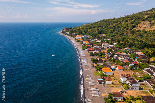 Amed, Bali: Aerial view of the Amed village with its beach lined with traditional fishing boat, the Jukung, and hotel and guesthouse in Bali northeast coast in Indonesia photo