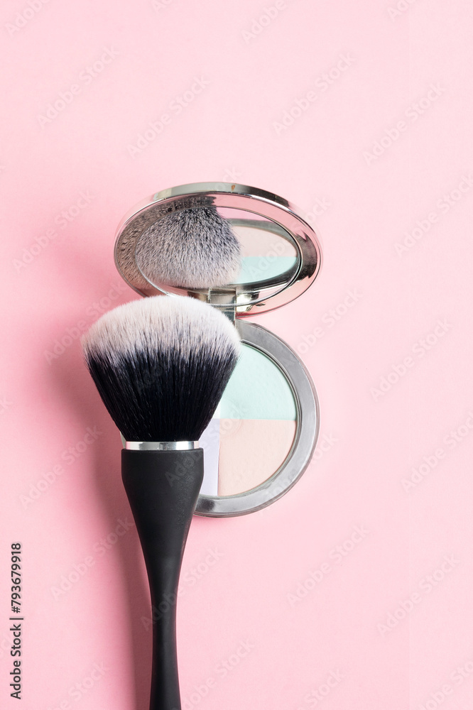 Top view of compact powder with different correcting colours and black brush on pink background, close up - obrazy, fototapety, plakaty 