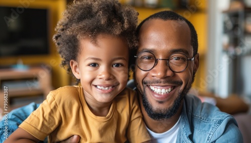 Man and toddler on couch, sharing a happy smile for snapshot