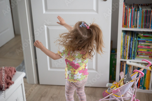 little girl having fun at home, movement and hair © skypictom