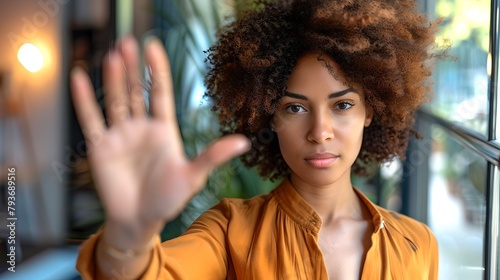 Young woman in stylish attire signals stop with hand, portrait in urban setting. Empowerment and boundary setting theme. AI