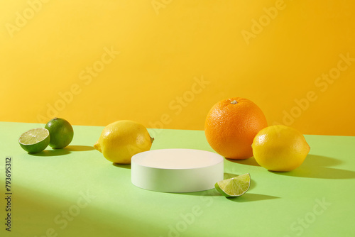 Citrus fruit template with empty podium in center for display product on green table, orange background. Blank space for text and designing