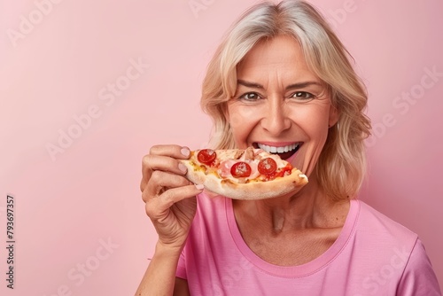 Senior woman savoring pizza portrait on pastel background with ample space for text placement