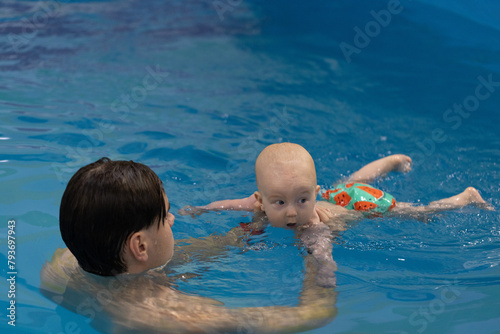 Baby drinking water of swimming pool. Disinfection and cleaning of swimming pool.
