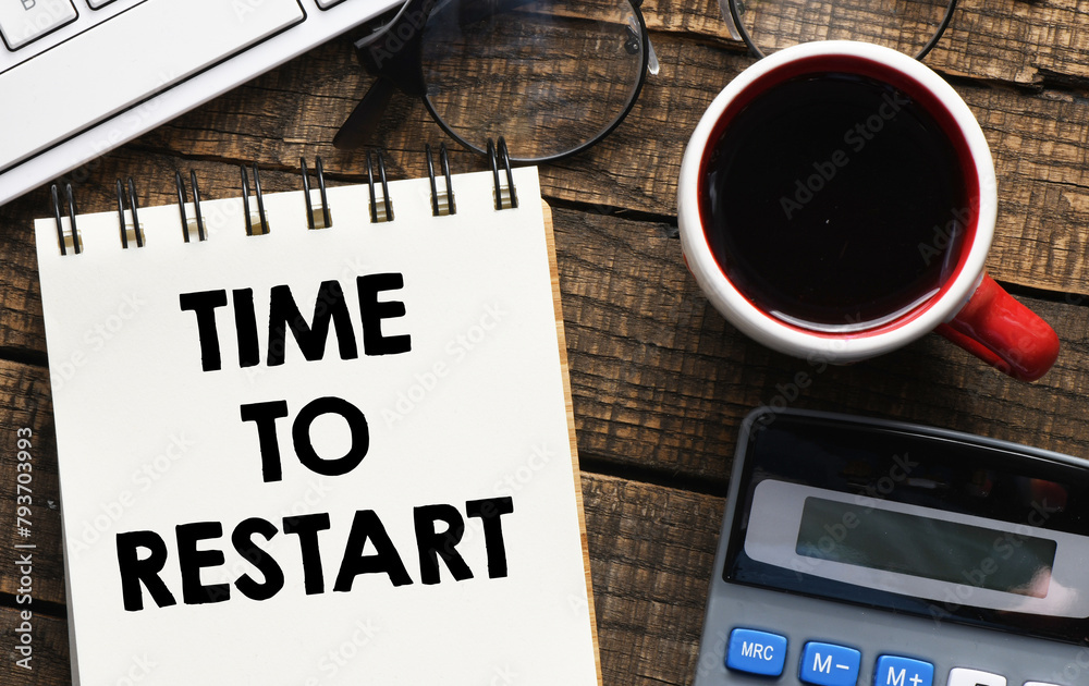 TIME TO RESTART text written in an office notebook. TIME TO RESTART text written in an office notebook.