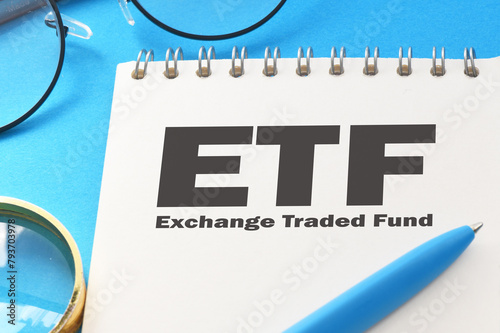 ETF - Exchange Traded Fund words in office notebook - concept.