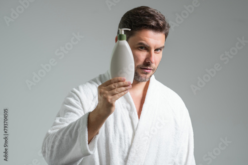 Cosmetic products. Beauty man presentation cosmetic bottle, bottle with dispenser pump for liquid soap, gel or foam. Natural cosmetics cream, spa beauty products. Man advertising cosmetic.