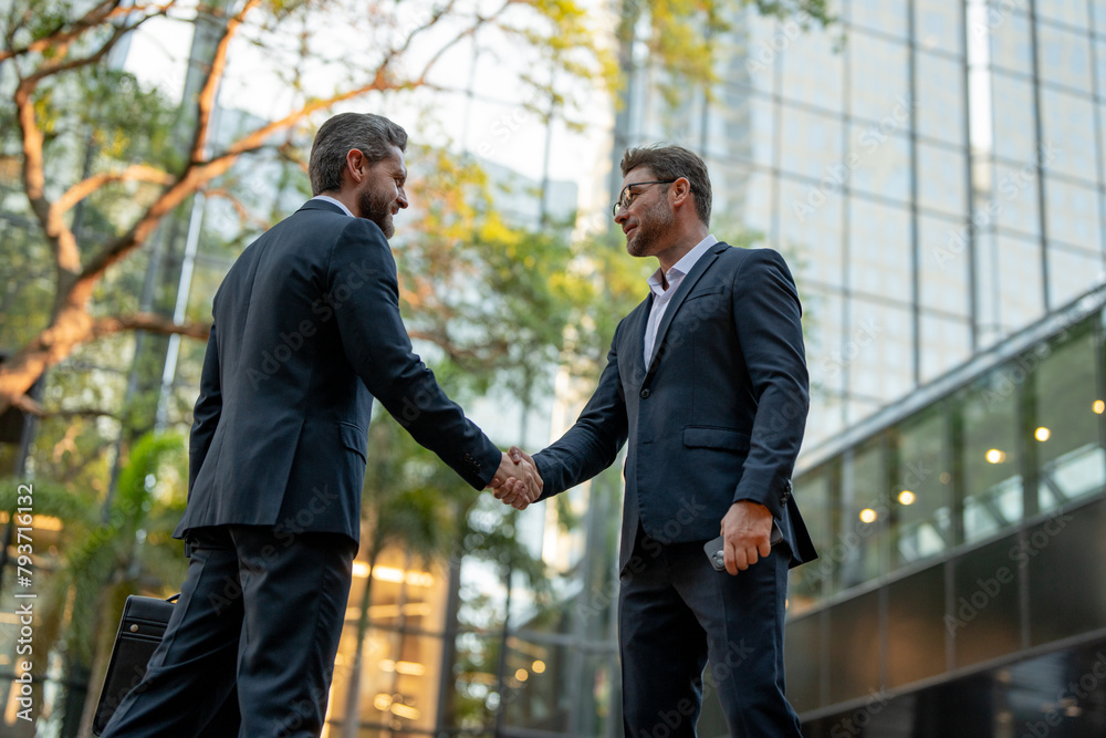 Business man shaking hands. Two businessmen handshake outdoor. Handshake business people. Handshake of two business man in suit outdoor. Businessmen great partnership.