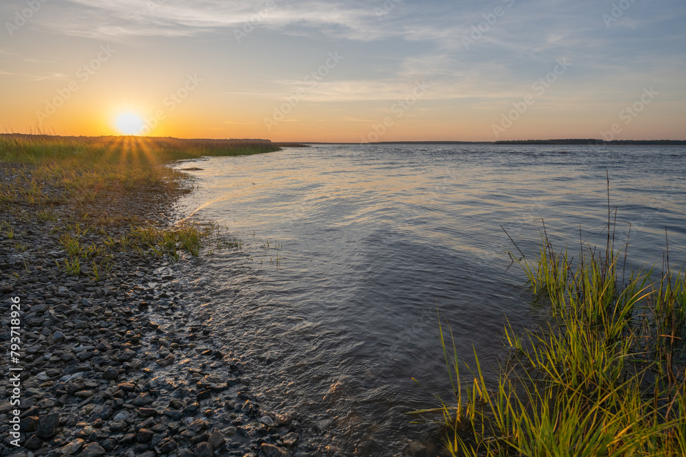 Sunset next to river with marsh grasses Sunset next to river with marsh grasses