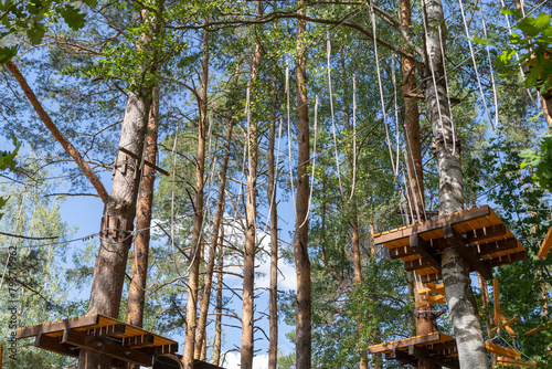 High ropes experience adventure tree park. Rope road course in trees. 