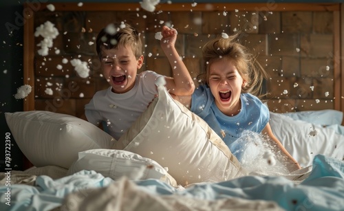 Siblings having a pillow fight in their bedroom photo