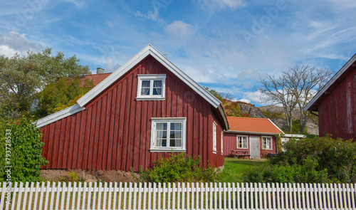 red typical house with white fence in front in a sweden village © coco