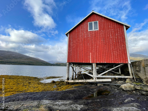 old typical red hut on stilts at the edge on the sea in Sweden scandinavia © coco