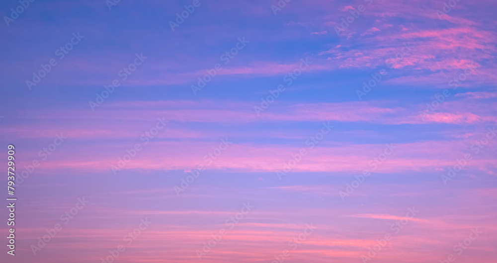 Colorful evening sky background with thin clouds streak on beautiful romantic pastel pink and blue sunset sky backdrop
