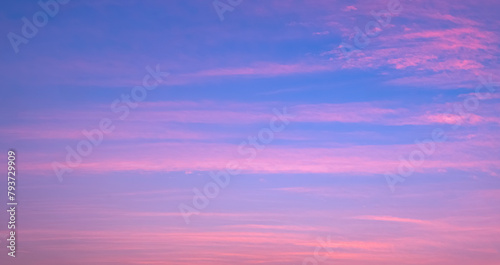 Colorful evening sky background with thin clouds streak on beautiful romantic pastel pink and blue sunset sky backdrop © Prapat