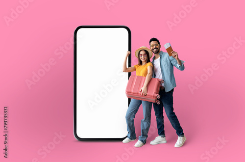 Playful couple presenting a large smartphone screen