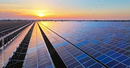 Aerial view of solar power plant in lake at sunset photo